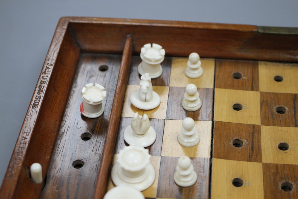 A late 19th century Jaques , London Travelling In Statu Quo travelling chess set, the folding mahogany case containing a boxwood and